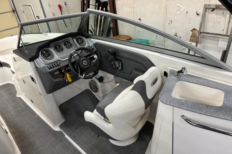 Slide: The Image of Storage compartment in 2015 Chaparral 244 Sunesta boat with life jackets and portable toilet. - 12