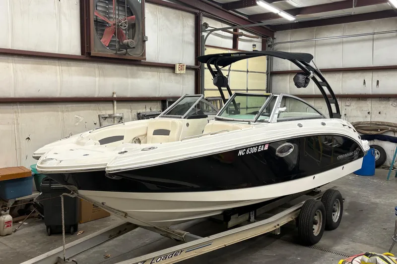 Slide: The Image of 2015 Chaparral 244 Sunesta boat in a warehouse, rear view on trailer. - 2
