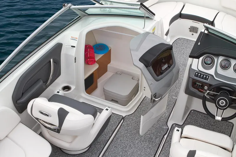 Slide: The Image of Manufacturer Provided Image: 2015 Chaparral 244 Sunesta boat interior with seating and dashboard on water. - 24