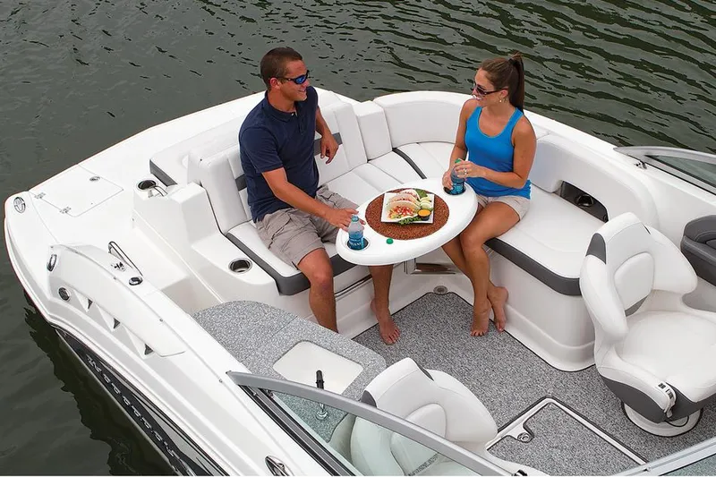 Slide: The Image of Manufacturer Provided Image: 2015 Chaparral 244 Sunesta boat interior with seating and dashboard, on water. - 27