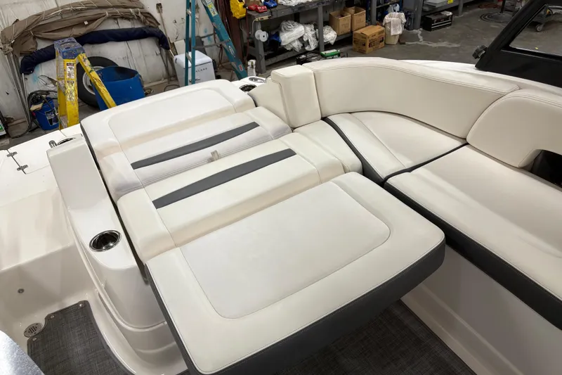 Slide: The Image of Interior of 2015 Chaparral 244 Sunesta boat with white seating and gray flooring. - 6