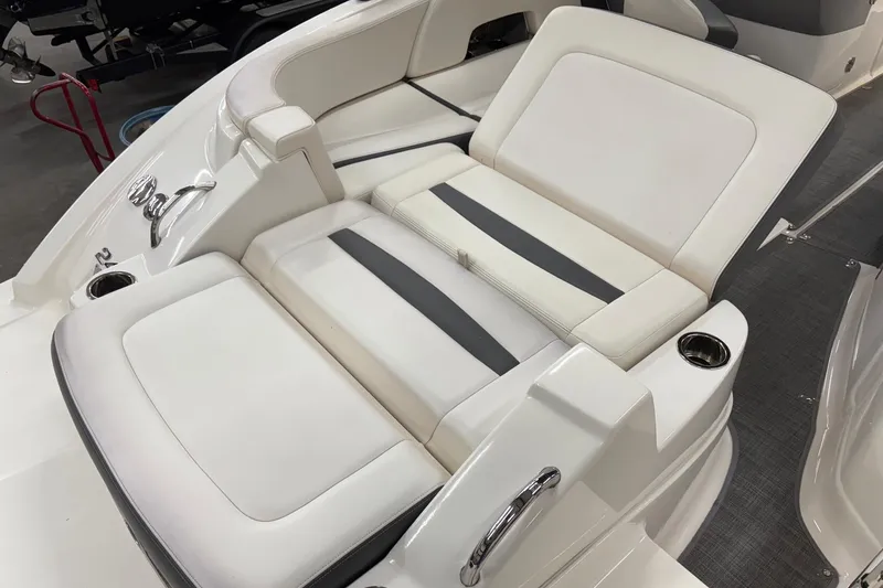 Slide: The Image of 2015 Chaparral 244 Sunesta boat interior seating, featuring white and gray upholstery. - 8