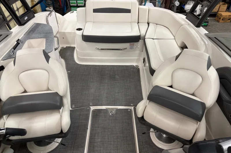 Slide: The Image of 2015 Chaparral 244 Sunesta boat interior with white and gray seating. - 9
