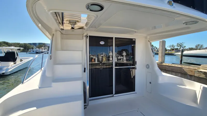 Slide: The Image of 2006 Sea Ray 44 Sedan Bridge yacht with spacious deck and sliding glass doors. - 10