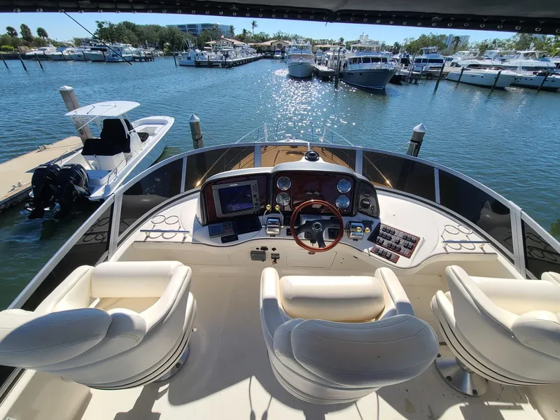 Slide: The Image of Helm of 2006 Sea Ray 44 Sedan Bridge yacht with marina view. - 11