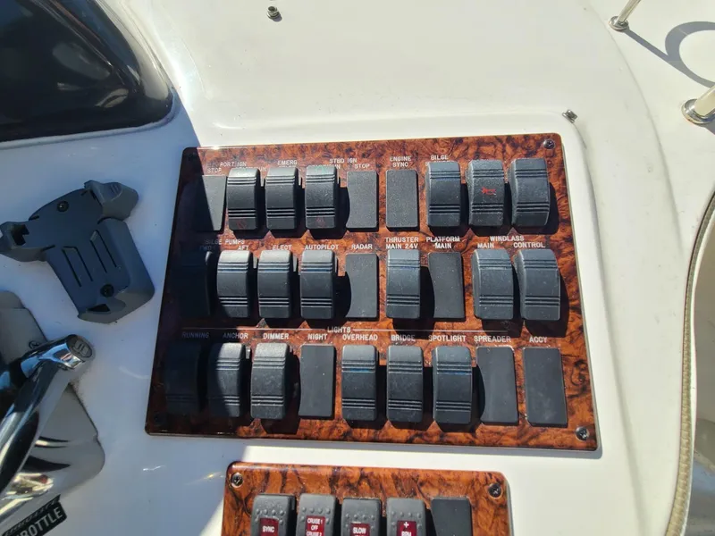 Slide: The Image of Control panel of a 2006 Sea Ray 44 Sedan Bridge yacht with multiple switches. - 12