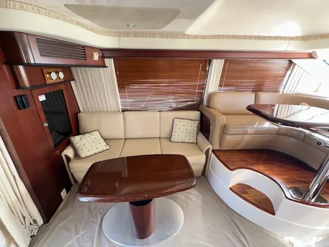Slide: The Image of Luxurious interior of 2006 Sea Ray 44 Sedan Bridge yacht with elegant seating and wooden accents. - 14