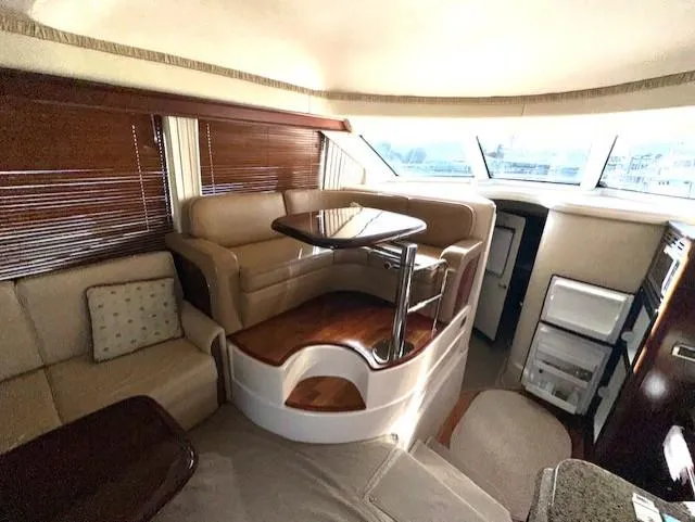 Slide: The Image of Interior of 2006 Sea Ray 44 Sedan Bridge yacht with elegant seating and wooden accents. - 15