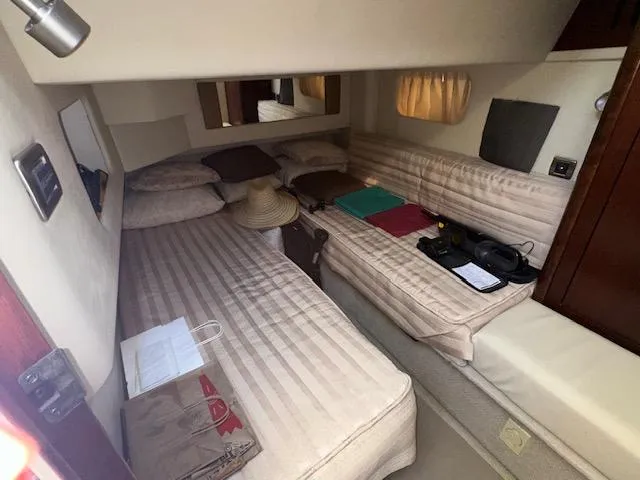 Slide: The Image of 2006 Sea Ray 44 Sedan Bridge cabin interior with twin beds and cozy decor. - 18