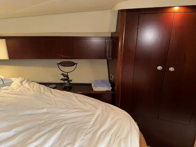 Slide: The Image of Interior cabin of 2006 Sea Ray 44 Sedan Bridge with wooden cabinetry and bed. - 22