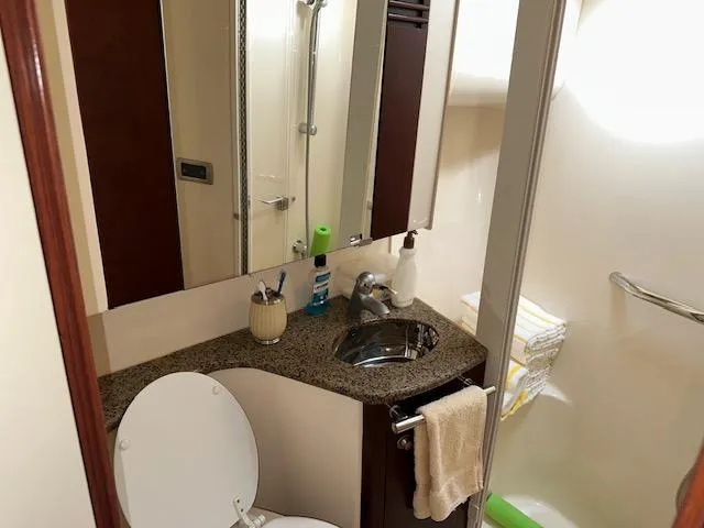 Slide: The Image of Bathroom interior of 2006 Sea Ray 44 Sedan Bridge yacht, featuring sink and mirror. - 23