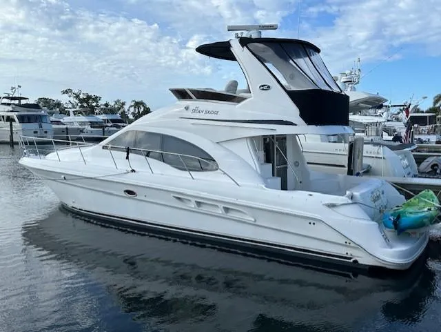 Slide: The Image of 2006 Sea Ray 44 Sedan Bridge yacht docked in marina, side view. - 3