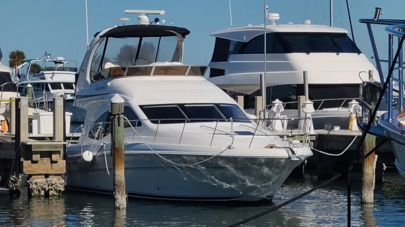 Slide: The Image of 2006 Sea Ray 44 Sedan Bridge yacht docked at marina, surrounded by other boats. - 4
