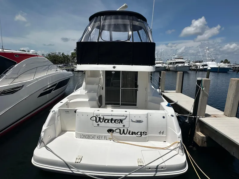 Slide: The Image of 2006 Sea Ray 44 Sedan Bridge yacht docked at marina under clear sky. - 6