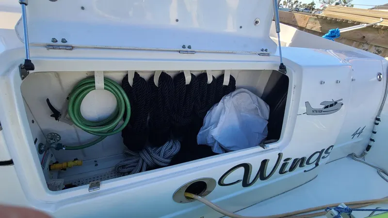 Slide: The Image of Open storage compartment on 2006 Sea Ray 44 Sedan Bridge boat with ropes and hose. - 9