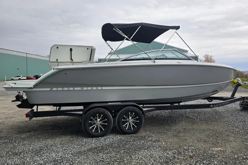 Slide: The Image of 2025 Four Winns H4 Freedom boat interior with cushioned seating and sleek design. - 11