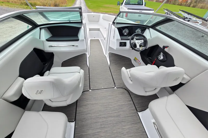 Slide: The Image of 2025 Four Winns H4 Freedom boat interior with modern helm and comfortable seating. - 16