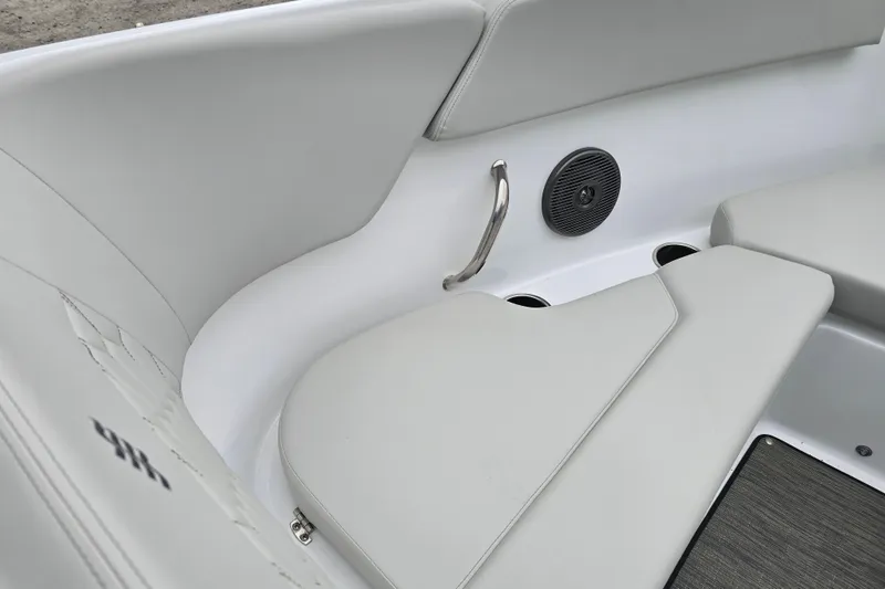 Slide: The Image of Interior of 2025 Four Winns H4 Freedom boat, featuring steering wheel and throttle controls. - 18