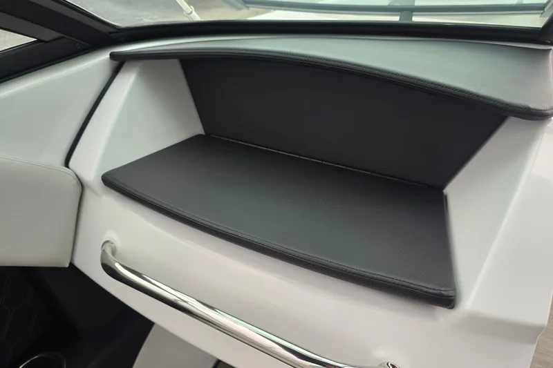 Slide: The Image of 2025 Four Winns H4 Freedom boat interior with white seating and cup holders. - 30