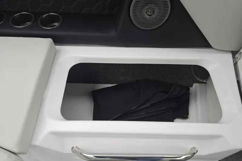 Slide: The Image of 2025 Four Winns H4 Freedom boat on trailer, gray exterior, parked outdoors. - 36