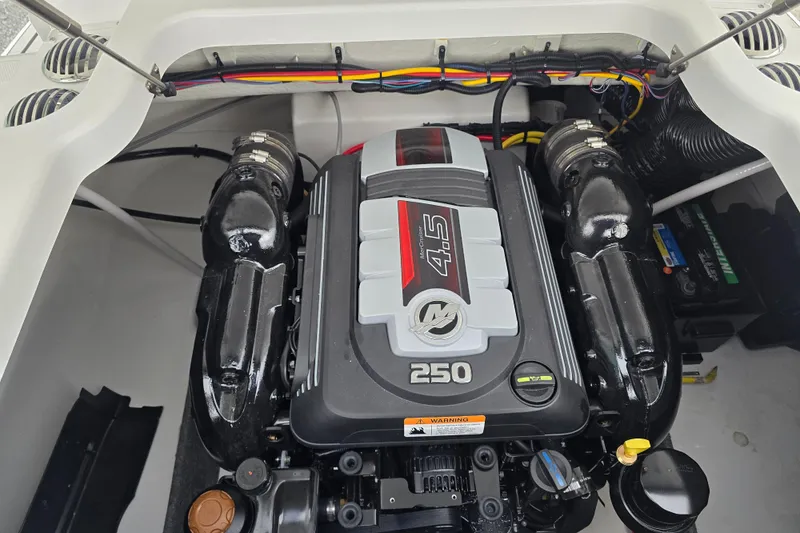 Slide: The Image of 2025 Four Winns H4 Freedom boat on trailer, parked near a garage. - 37