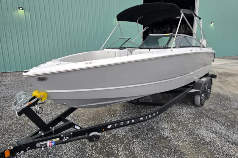 Slide: The Image of 2025 Four Winns H4 Freedom boat interior with modern seating and sleek dashboard design. - 8