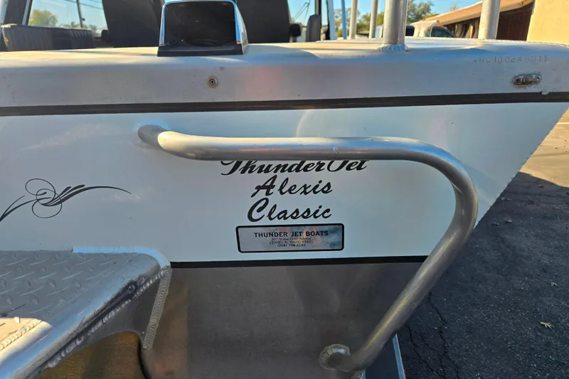 Slide: The Image of 2011 Thunderjet Alexis Classic boat with railing and logo detail. - 12
