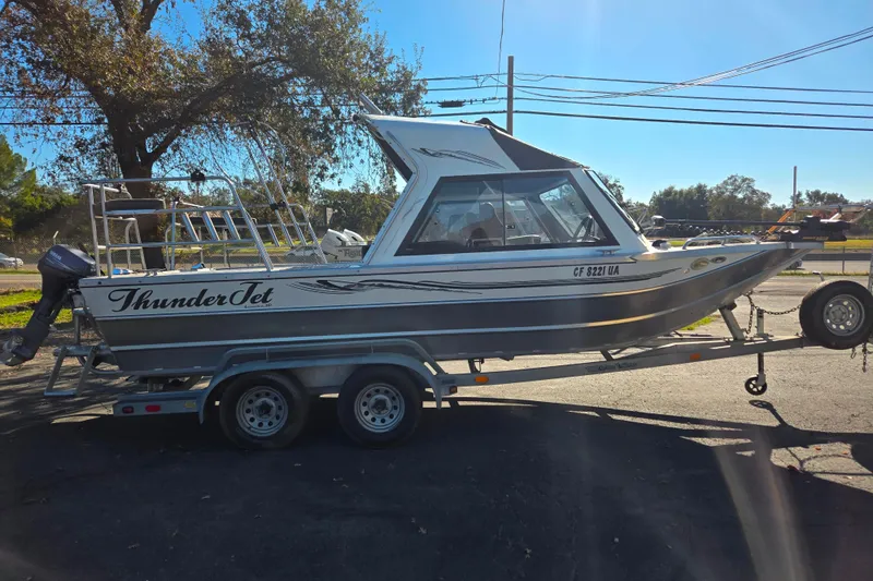 Slide: The Image of 2011 Thunderjet ALEXIS CLASSIC boat on trailer, parked outdoors under clear sky. - 20