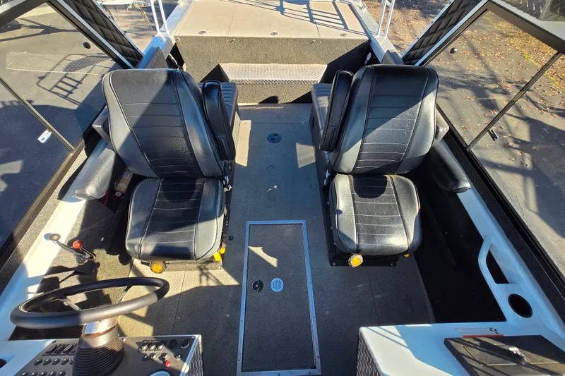 Slide: The Image of 2011 Thunderjet ALEXIS CLASSIC boat interior with two black seats and steering wheel. - 5