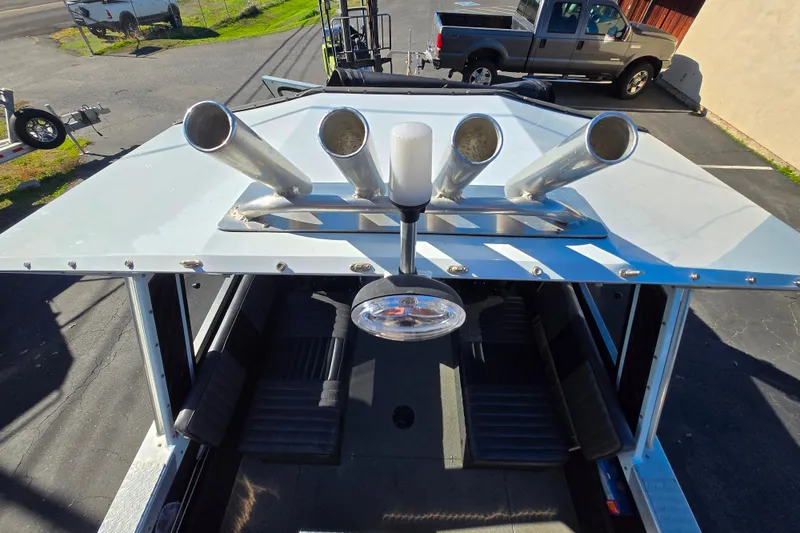 Slide: The Image of 2011 Thunderjet ALEXIS CLASSIC boat with rod holders and seating, parked outdoors. - 8
