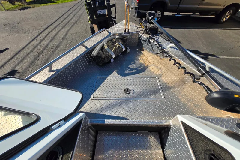 Slide: The Image of 2011 Thunderjet ALEXIS CLASSIC boat deck with diamond plate flooring and trolling motor. - 9