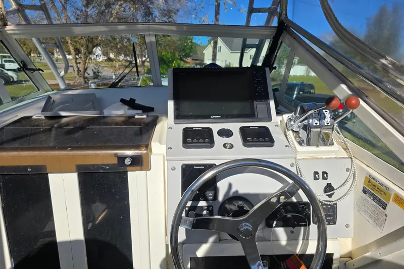 Slide: The Image of 1990 Hydra-Sports 2500WA boat cockpit with steering wheel and navigation controls. - 10