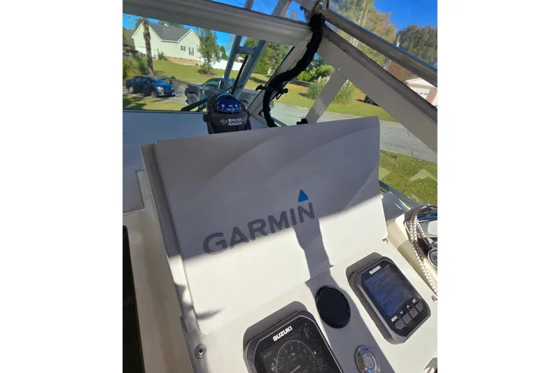 Slide: The Image of 1990 Hydra-Sports 2500WA boat dashboard with Garmin navigation system and Suzuki controls. - 11