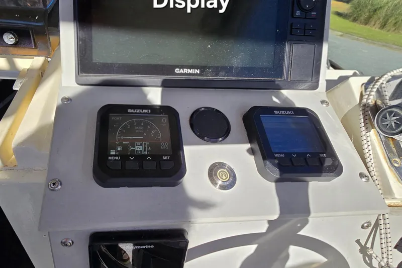 Slide: The Image of 1990 Hydra-Sports 2500WA boat dashboard with Garmin display and Suzuki controls. - 12