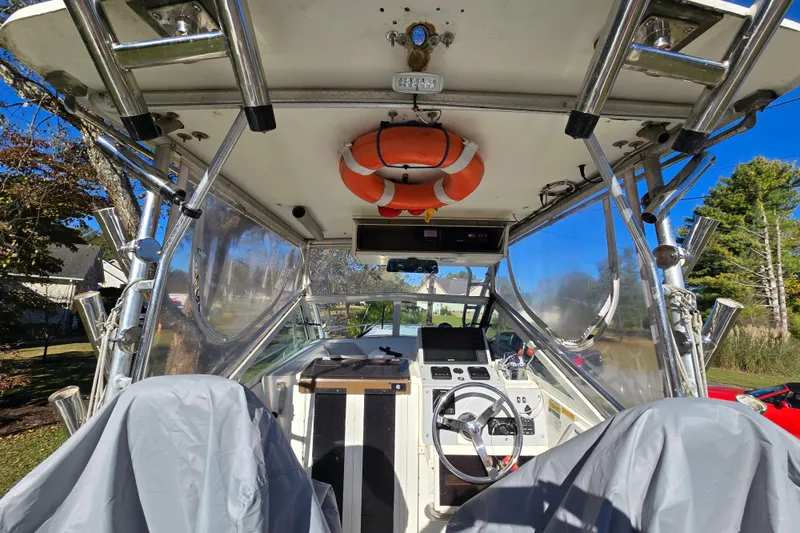 Slide: The Image of 1990 Hydra-Sports 2500WA boat interior with steering wheel and life preserver. - 14