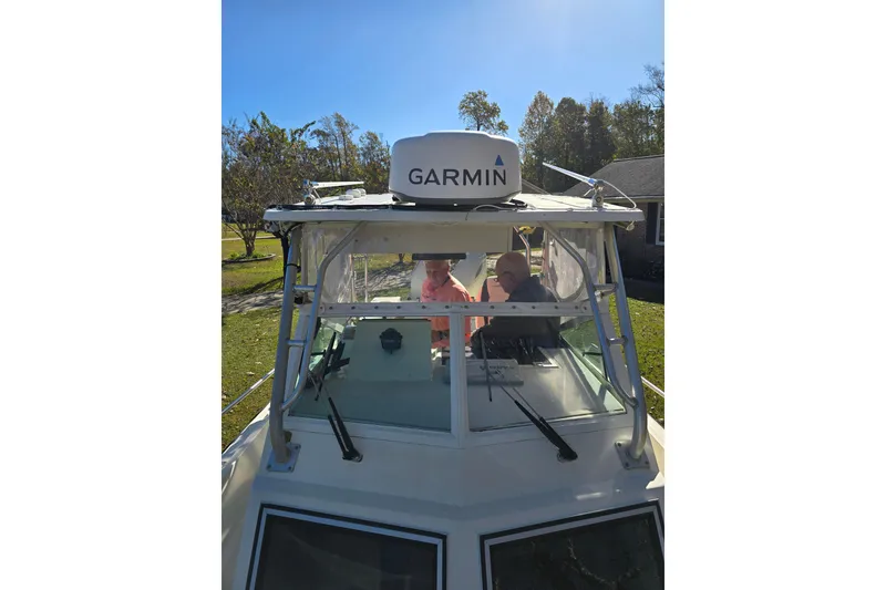 Slide: The Image of 1990 Hydra-Sports 2500WA boat with Garmin equipment, docked in a sunny yard. - 22