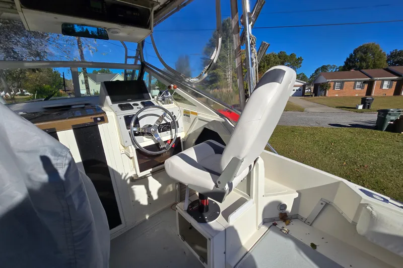 Slide: The Image of 1990 Hydra-Sports 2500WA boat interior with steering wheel and captain's chair. - 24