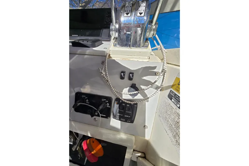 Slide: The Image of Control panel of a 1990 Hydra-Sports 2500WA boat with throttle and switches. - 27
