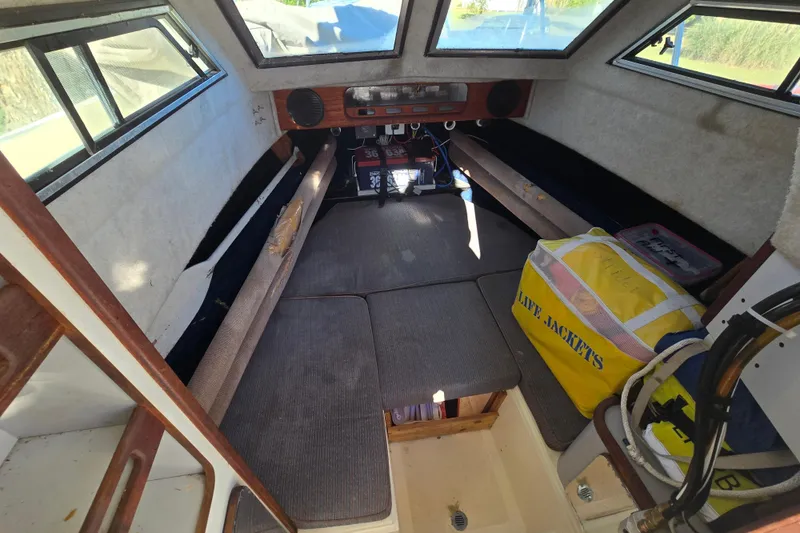 Slide: The Image of Interior of a 1990 Hydra-Sports 2500WA boat with seating and life jackets. - 29