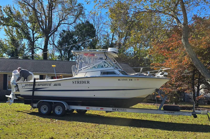 Slide: The Image of 1990 Hydra-Sports 2500WA boat on trailer, parked in a grassy yard. - 32
