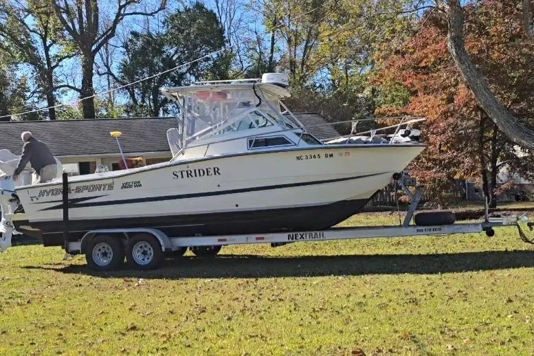 Slide: The Image of 1990 Hydra-Sports 2500WA boat on trailer, parked on grass, surrounded by trees. - 35
