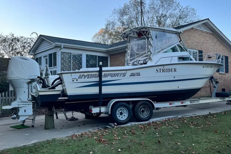 Slide: The Image of 1990 Hydra-Sports 2500WA boat on trailer, parked in front of a house. - 6