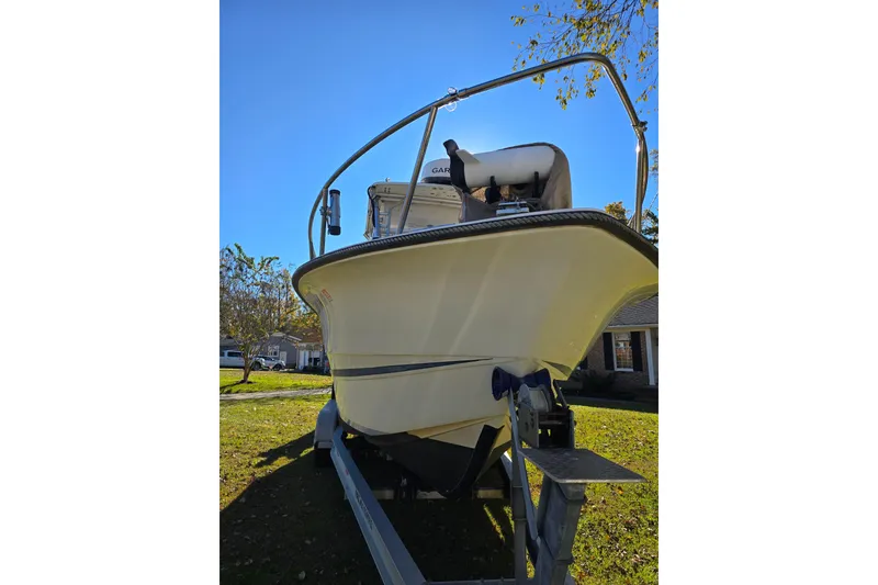 Slide: The Image of 1990 Hydra-Sports 2500WA boat on trailer, parked on grass under clear blue sky. - 8