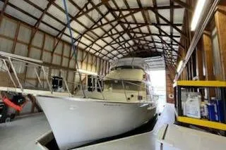 Slide: The Image of 1980 Custom Boathouse with yacht inside, wooden roof structure, spacious interior. - 6