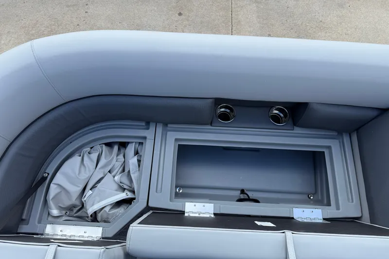 Slide: The Image of 2026 Bentley Pontoons Legacy 223 Cruise XL interior storage compartment with cup holders. - 11