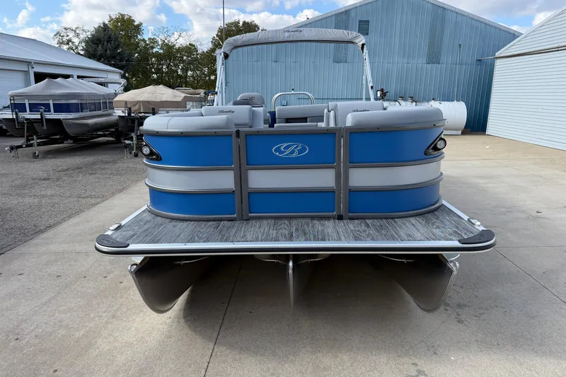 Slide: The Image of 2026 Bentley Pontoons Legacy 223 Cruise XL, blue pontoon boat, docked outdoors. - 2