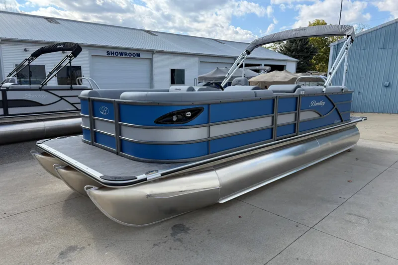 Slide: The Image of 2026 Bentley Pontoons Legacy 223 Cruise XL in showroom, blue and silver design. - 3