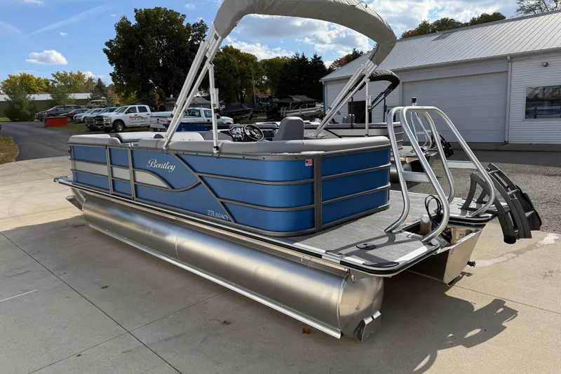 Slide: The Image of 2026 Bentley Pontoons Legacy 223 Cruise XL, blue pontoon boat, parked outdoors. - 5