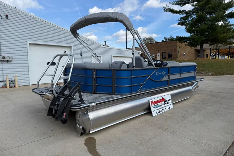 Slide: The Image of 2026 Bentley Pontoons Legacy 223 Cruise XL in a driveway, featuring blue exterior and canopy. - 7