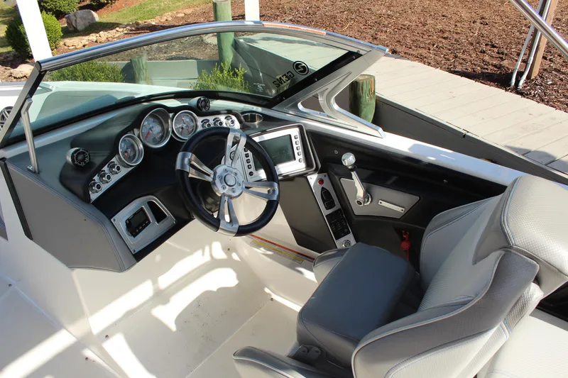 Slide: The Image of 2016 MasterCraft X30 boat interior with steering wheel and dashboard controls. - 10